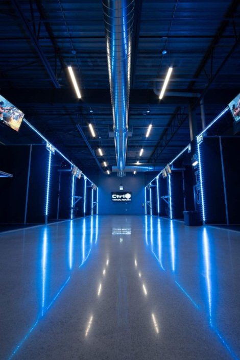 vr-business Spacious Ctrl V Virtual Reality gaming venue with neon blue illuminated pathways leading to multiple VR stations