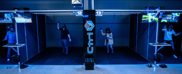 vr-owners-gaming Players enjoying state-of-the-art virtual reality games in a high-tech VR arcade with individual gaming pods and advanced VR headsets